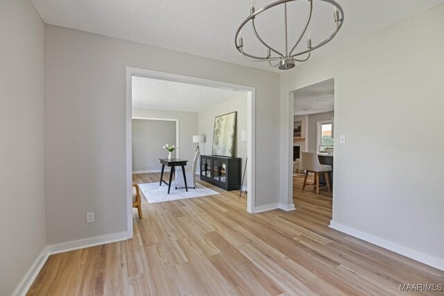 5010 Redland Rd, Wetumpka, AL 36093 - unfurnished dining area featuring light wood-type flooring and a chandelier