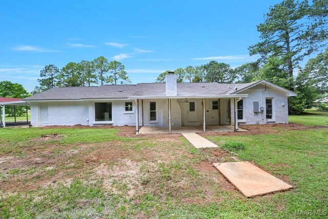 5010 Redland Rd, Wetumpka, AL 36093 - rear view of house with brick siding, a chimney, a patio, and a yard