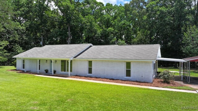 5010 Redland Rd, Wetumpka, AL 36093 - view of front of property featuring a front lawn, a porch, brick siding, roof with shingles, and an attached carport