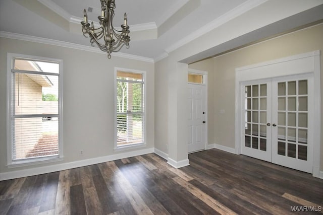 831 Windsong Loop, Wetumpka, AL 36093 - unfurnished dining area featuring french doors, a tray ceiling, a chandelier, dark wood-style flooring, and crown molding