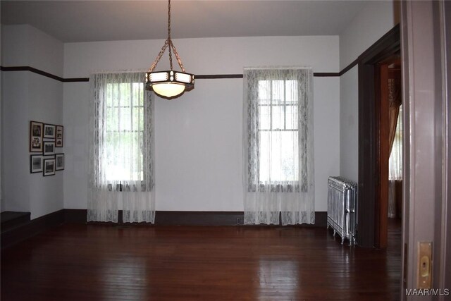 2207 Winona Ave, Montgomery, AL 36107 - empty room featuring radiator heating unit and hardwood / wood-style flooring