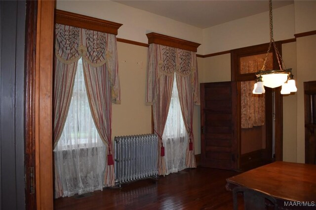 2207 Winona Ave, Montgomery, AL 36107 - spare room with radiator, hardwood / wood-style flooring, and a chandelier