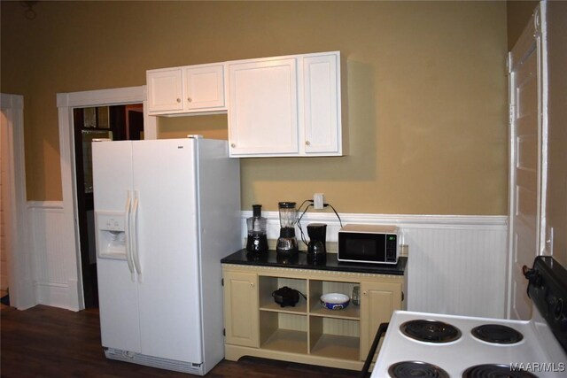 2207 Winona Ave, Montgomery, AL 36107 - kitchen featuring white appliances, a wainscoted wall, white cabinets, and dark wood-type flooring