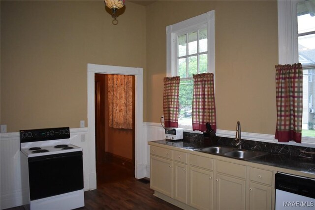 2207 Winona Ave, Montgomery, AL 36107 - kitchen featuring white appliances, a wainscoted wall, white cabinets, and dark wood-style flooring