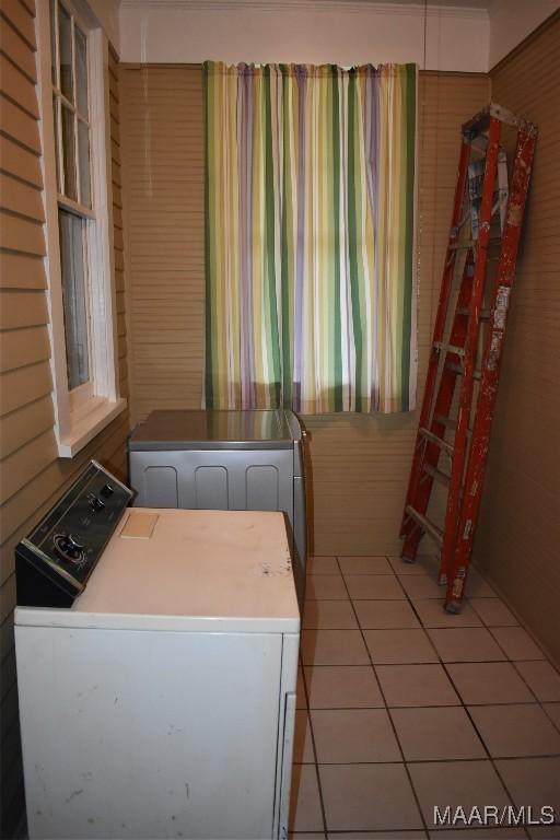 2207 Winona Ave, Montgomery, AL 36107 - washroom with washing machine and clothes dryer and light tile patterned flooring