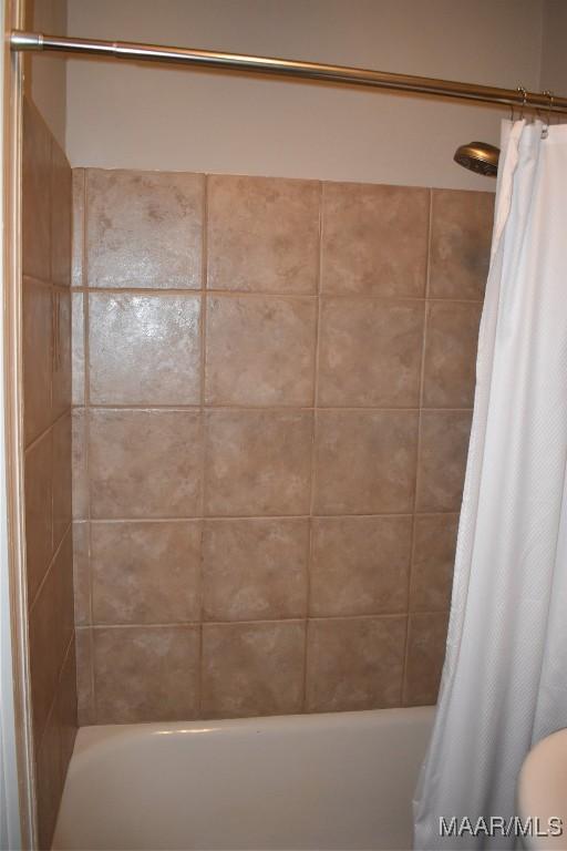 2207 Winona Ave, Montgomery, AL 36107 - bathroom featuring shower / bath combo with shower curtain
