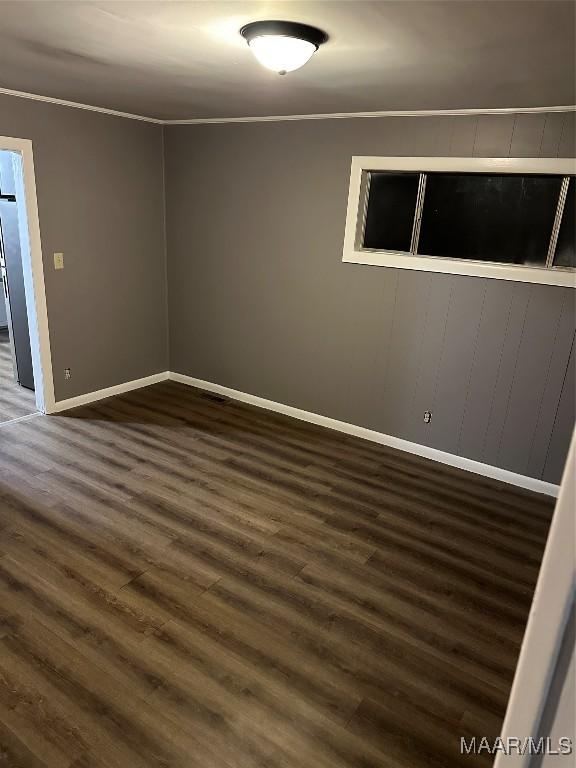 705 Mastin Lake Rd NW, Huntsville, AL 35811 - spare room with dark wood-type flooring and crown molding