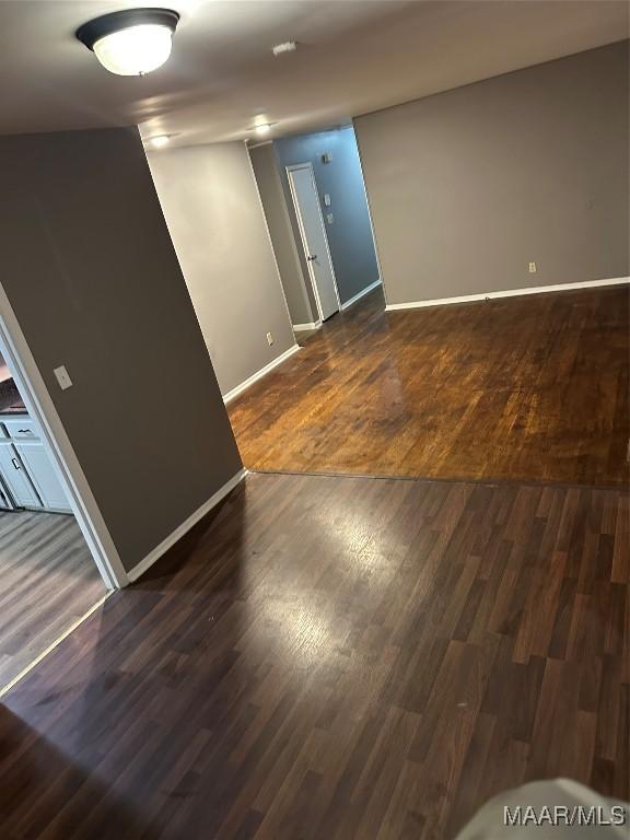 705 Mastin Lake Rd NW, Huntsville, AL 35811 - empty room with dark wood-style floors and a smoke detector