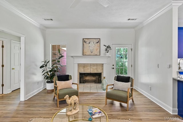 25 Sandy Springs Dr, Wetumpka, AL 36092 - living area with wood finished floors, crown molding, a fireplace, a textured ceiling, and ceiling fan