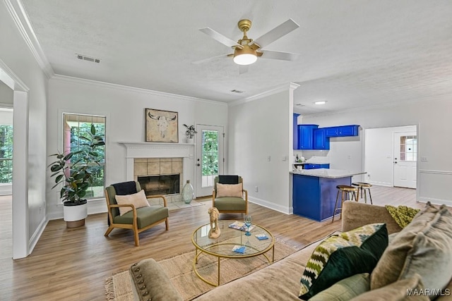 25 Sandy Springs Dr, Wetumpka, AL 36092 - living area featuring plenty of natural light, light wood finished floors, ornamental molding, and a textured ceiling