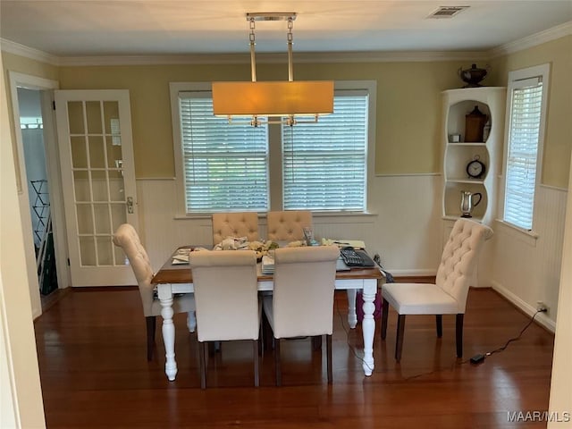 119 Mallory Dr, Selma, AL 36701 - dining space featuring a wainscoted wall, healthy amount of natural light, wood finished floors, and crown molding
