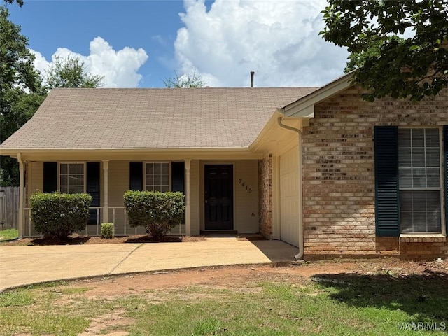 7415 Brampton Ln, Montgomery, AL 36117 - ranch-style house featuring an attached garage, concrete driveway, brick siding, and a porch