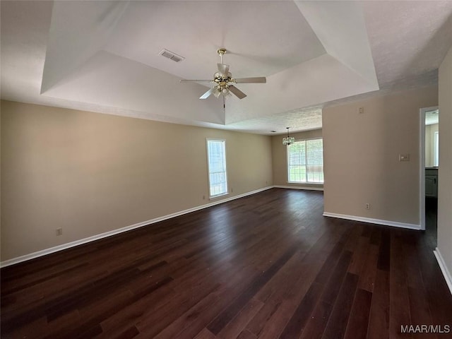 7415 Brampton Ln, Montgomery, AL 36117 - unfurnished room featuring a tray ceiling, a ceiling fan, dark wood-type flooring, and a chandelier