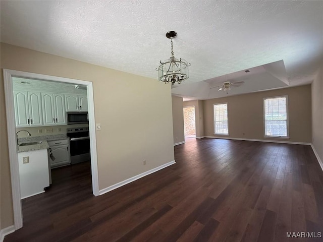 7415 Brampton Ln, Montgomery, AL 36117 - unfurnished dining area featuring dark wood-style floors, a textured ceiling, a chandelier, and ceiling fan