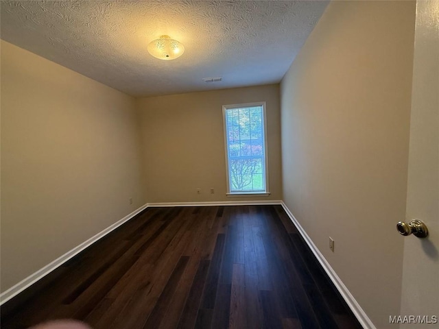 7415 Brampton Ln, Montgomery, AL 36117 - unfurnished room with dark wood-type flooring and a textured ceiling