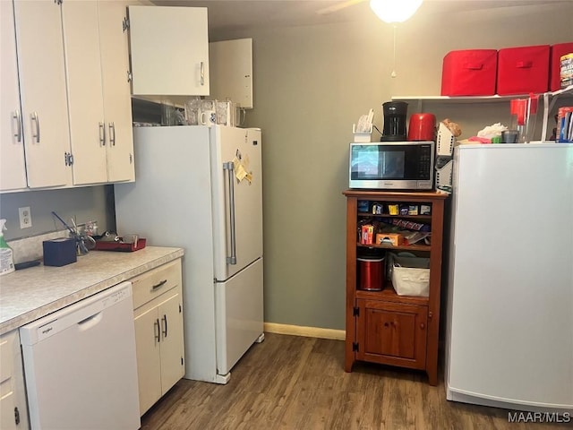 kitchen featuring white appliances, light countertops, wood finished floors, white cabinets, and a ceiling fan