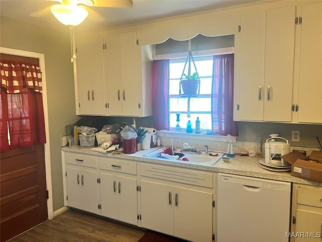 kitchen with dishwasher, light countertops, and white cabinetry