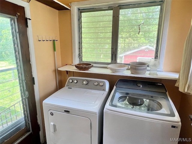 laundry room with washing machine and clothes dryer and plenty of natural light