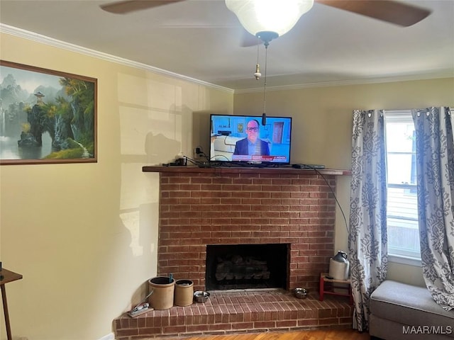 living room with crown molding, a fireplace, and wood finished floors