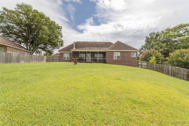 109 Inverness Rd, Wetumpka, AL 36092 - rear view of house with a sunroom, a fenced backyard, and brick siding