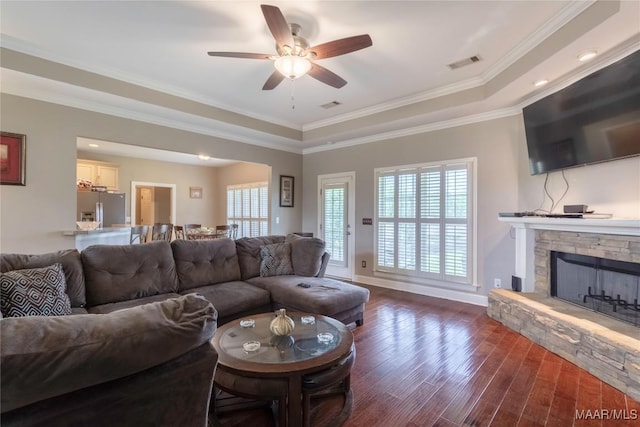 109 Inverness Rd, Wetumpka, AL 36092 - living area with dark wood-type flooring, a ceiling fan, a fireplace, a raised ceiling, and crown molding