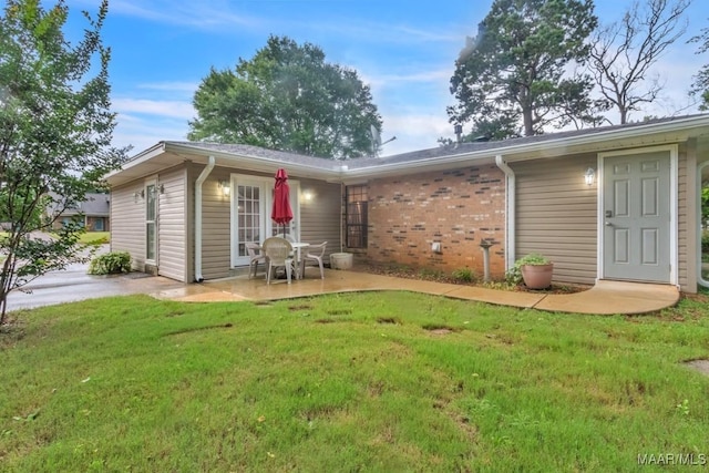 113 Duck Cv, Elmore, AL 36025 - back of house featuring a patio area, a yard, and brick siding