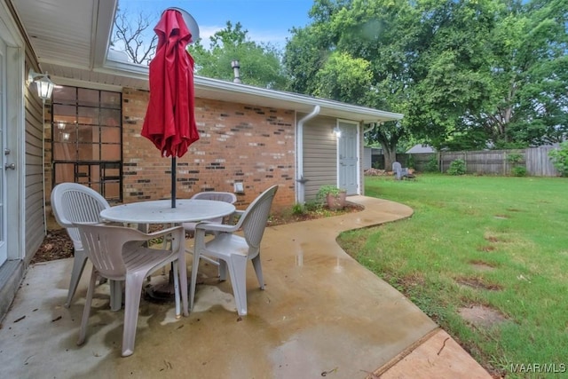 113 Duck Cv, Elmore, AL 36025 - fenced backyard with a patio area and outdoor dining space