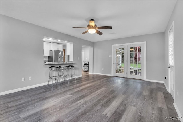 113 Duck Cv, Elmore, AL 36025 - unfurnished living room featuring ceiling fan, plenty of natural light, and dark wood-style floors