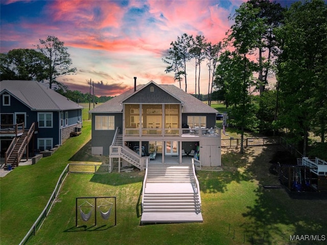 529 Hickory Dr, Wetumpka, AL 36092 - back of property featuring stairs, a sunroom, a fenced backyard, and a wooden deck
