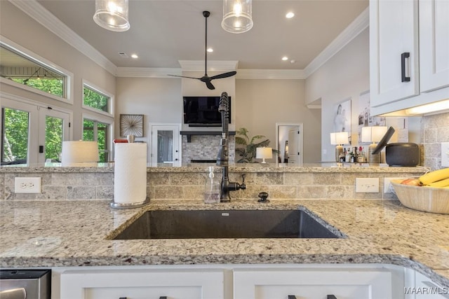 529 Hickory Dr, Wetumpka, AL 36092 - kitchen featuring tasteful backsplash, light stone counters, white cabinetry, a ceiling fan, and crown molding
