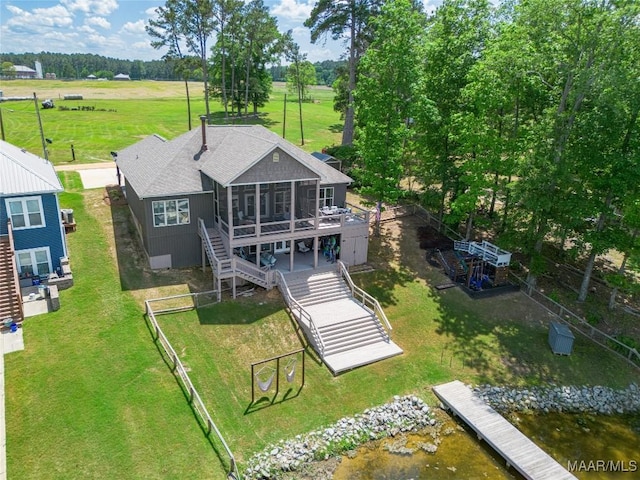 529 Hickory Dr, Wetumpka, AL 36092 - back of house featuring stairs, a sunroom, a deck with water view, a fenced backyard, and roof with shingles