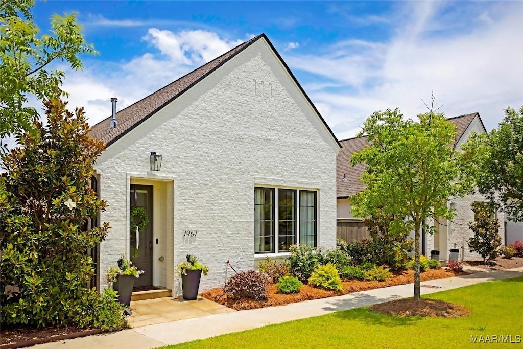 7967 Portman St, Montgomery, AL 36116 - view of side of home featuring a shingled roof and a lawn