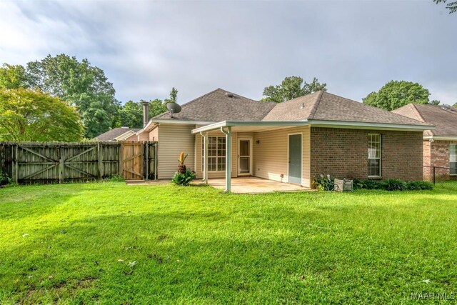 422 River Oaks Dr, Wetumpka, AL 36092 - back of property with a gate, a patio area, a fenced backyard, a shingled roof, and brick siding