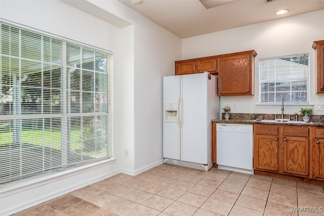 422 River Oaks Dr, Wetumpka, AL 36092 - kitchen with white appliances, brown cabinets, and healthy amount of natural light