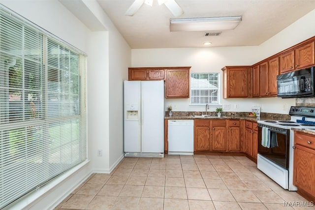 422 River Oaks Dr, Wetumpka, AL 36092 - kitchen featuring white appliances, brown cabinets, light tile patterned floors, and a ceiling fan