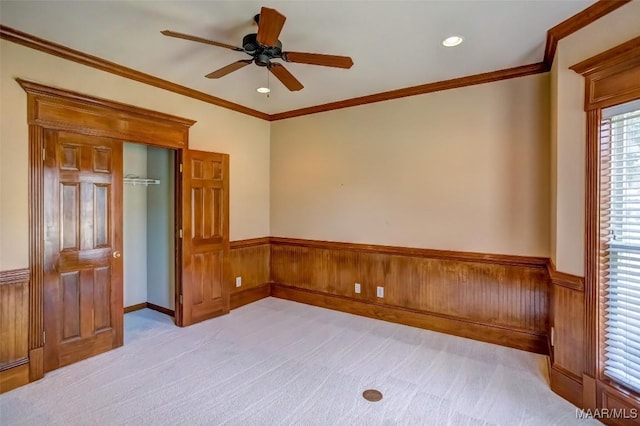 8330 Chadburn Way, Montgomery, AL 36116 - spare room featuring wainscoting, ceiling fan, light colored carpet, wood walls, and crown molding
