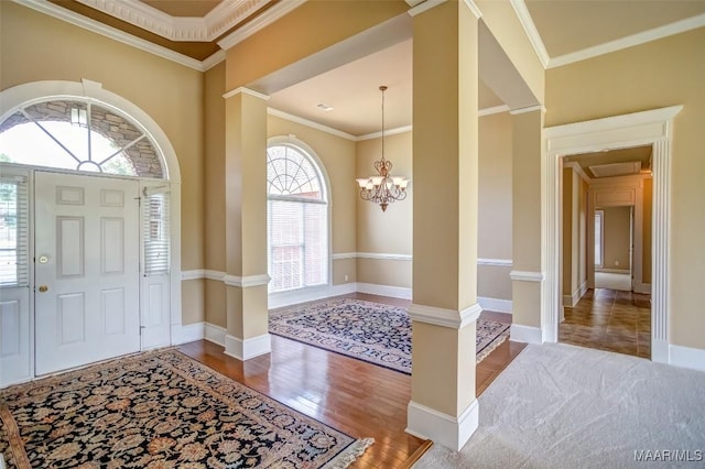 8330 Chadburn Way, Montgomery, AL 36116 - entryway featuring ornate columns, a chandelier, wood finished floors, and ornamental molding