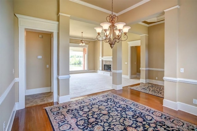 8330 Chadburn Way, Montgomery, AL 36116 - unfurnished dining area with wood finished floors, crown molding, a tile fireplace, a chandelier, and a ceiling fan