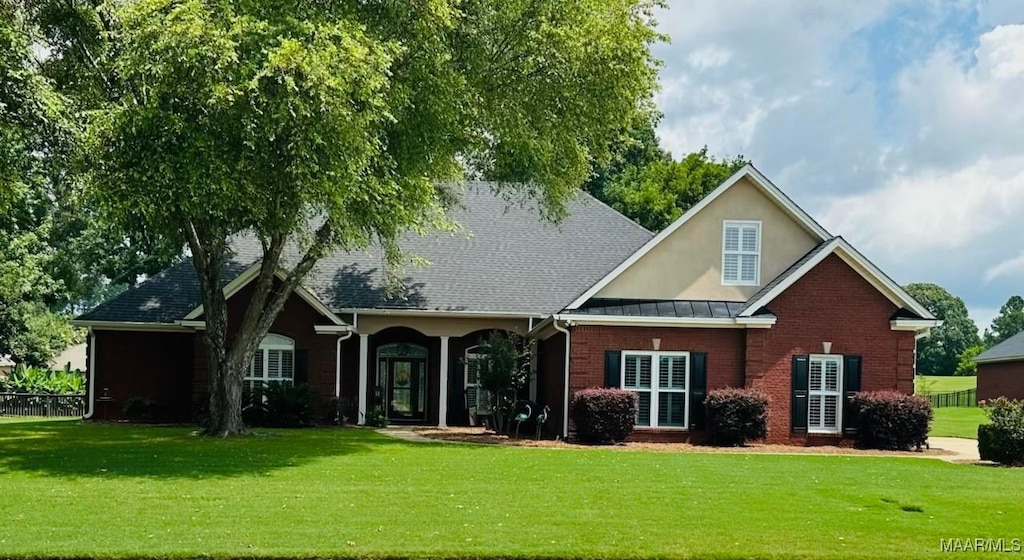 145 Mountain Meadows Ln, Wetumpka, AL 36093 - rear view of property featuring a lawn, brick siding, stucco siding, and a standing seam roof