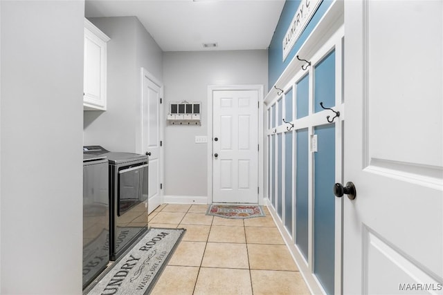 145 Mountain Meadows Ln, Wetumpka, AL 36093 - washroom featuring washer and dryer, cabinet space, and light tile patterned flooring