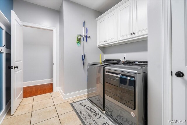 145 Mountain Meadows Ln, Wetumpka, AL 36093 - laundry room with washing machine and clothes dryer, cabinet space, and light tile patterned floors