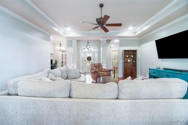 145 Mountain Meadows Ln, Wetumpka, AL 36093 - living area with a tray ceiling, a chandelier, ornamental molding, and a ceiling fan