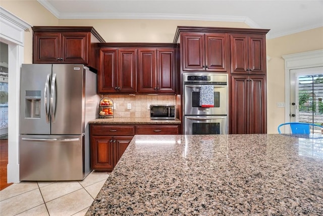 145 Mountain Meadows Ln, Wetumpka, AL 36093 - kitchen featuring stainless steel appliances, light stone counters, ornamental molding, tasteful backsplash, and light tile patterned flooring