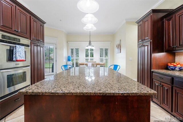 145 Mountain Meadows Ln, Wetumpka, AL 36093 - kitchen with double oven, light tile patterned floors, a kitchen island, light stone countertops, and tasteful backsplash