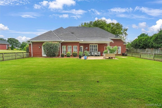 145 Mountain Meadows Ln, Wetumpka, AL 36093 - back of property with a patio, a fenced backyard, brick siding, and roof with shingles