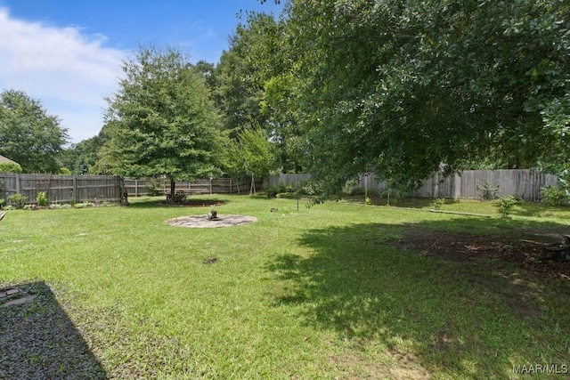204 St Thomas Ave, Wetumpka, AL 36092 - fenced backyard featuring an outdoor fire pit