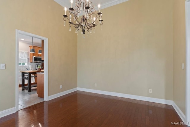 204 St Thomas Ave, Wetumpka, AL 36092 - empty room with hardwood / wood-style flooring, ornamental molding, and a chandelier