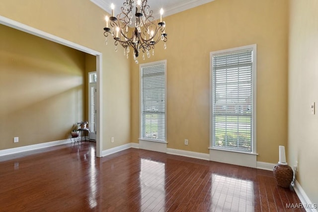 204 St Thomas Ave, Wetumpka, AL 36092 - spare room with dark wood finished floors, crown molding, and a chandelier
