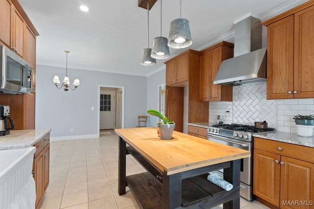 204 St Thomas Ave, Wetumpka, AL 36092 - kitchen featuring wall chimney range hood, appliances with stainless steel finishes, ornamental molding, brown cabinetry, and recessed lighting
