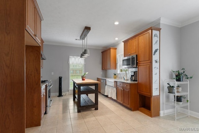 204 St Thomas Ave, Wetumpka, AL 36092 - kitchen with stainless steel appliances, backsplash, light tile patterned floors, brown cabinetry, and ornamental molding